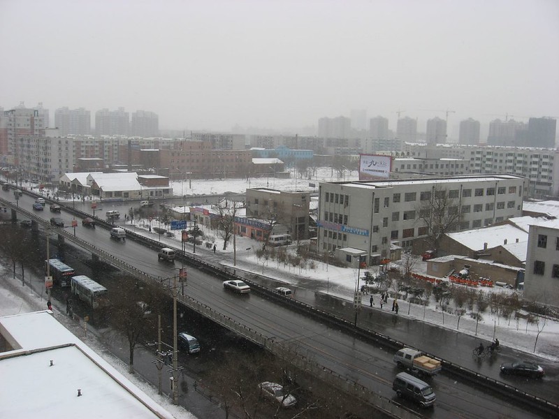 Improving solar-air source heat pump performance via heat grid